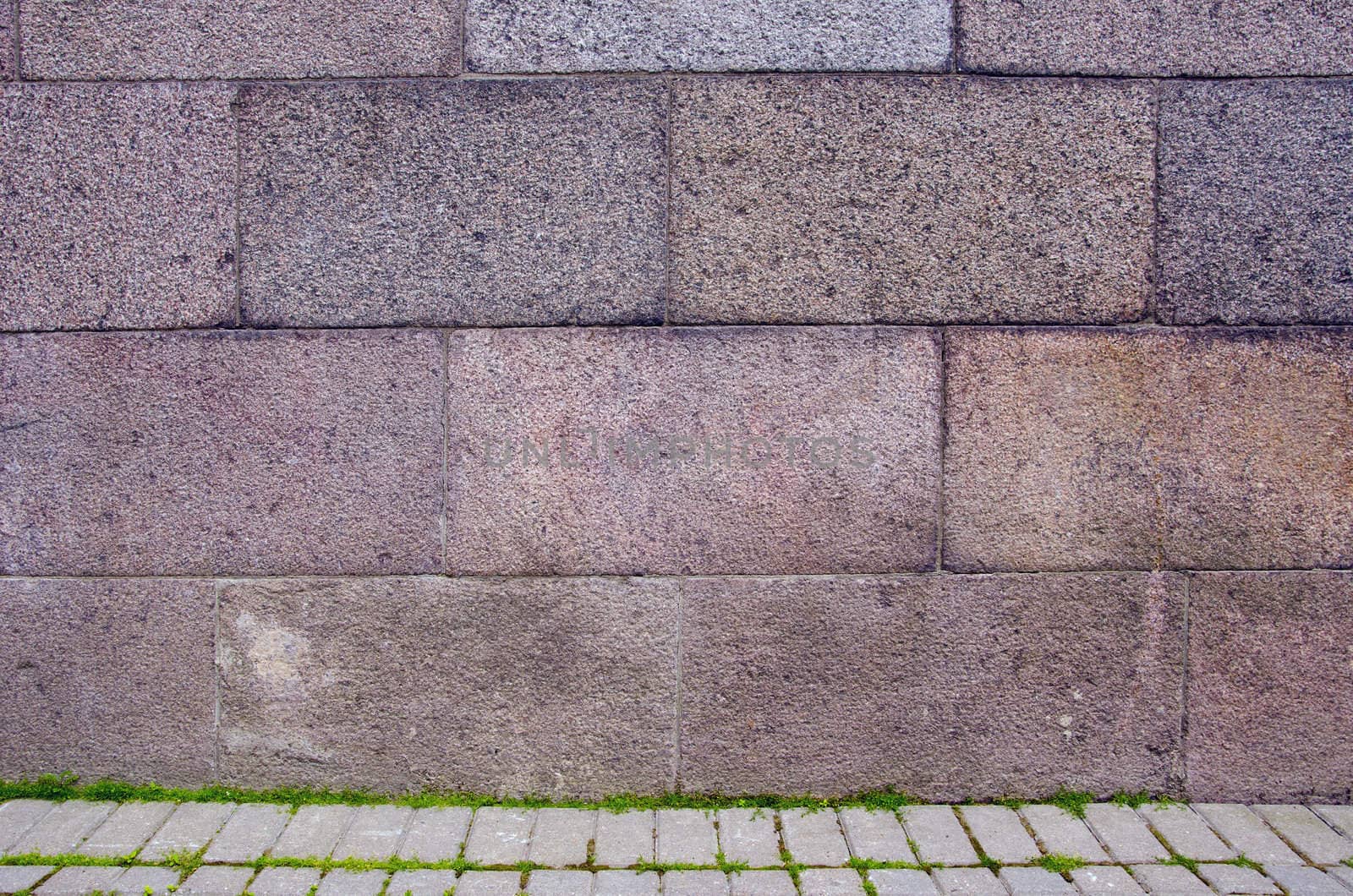 Block wall and tiled path fragments. Construction background.