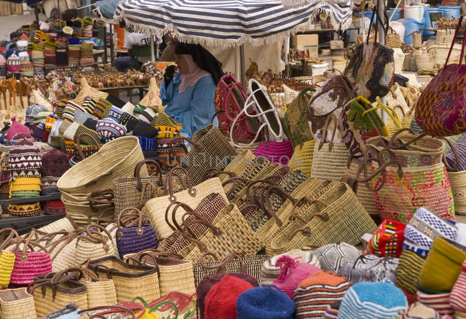 Woman selling baskets of all shapes and sizes in the main souk of Marrakesh, Morocco.