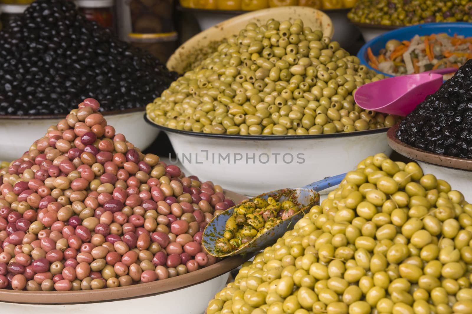 Market stall selling fresh olives in the main souk of Marrakesh, Morocco.