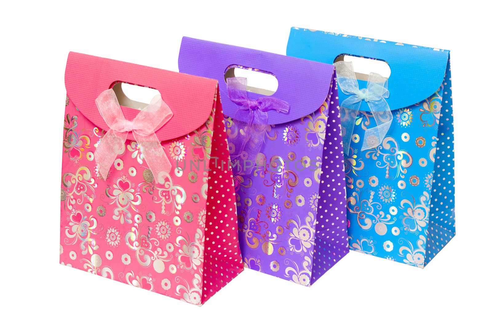 three multi-colored cardboard gift pack with an internal handle