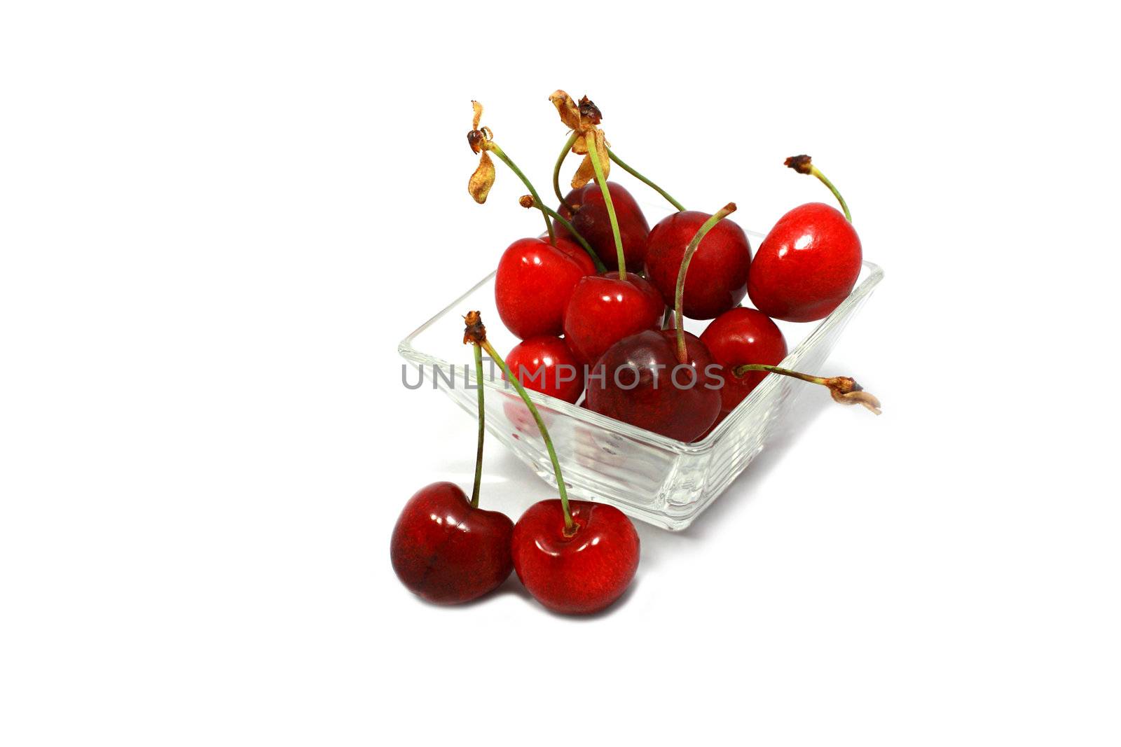 fresh delicious cherry in the transparent bowl on white