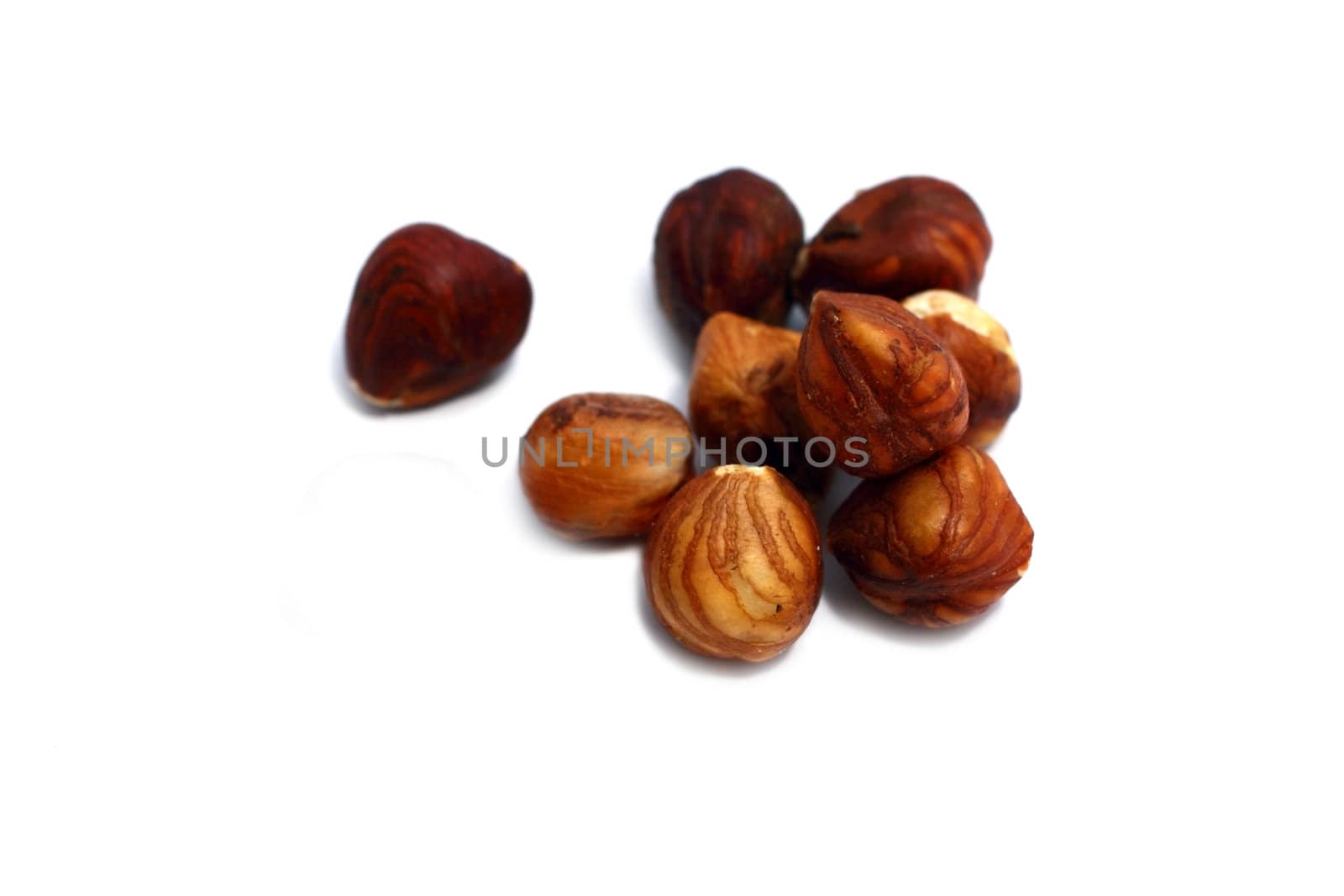 few dry hazelnuts isolated on white background