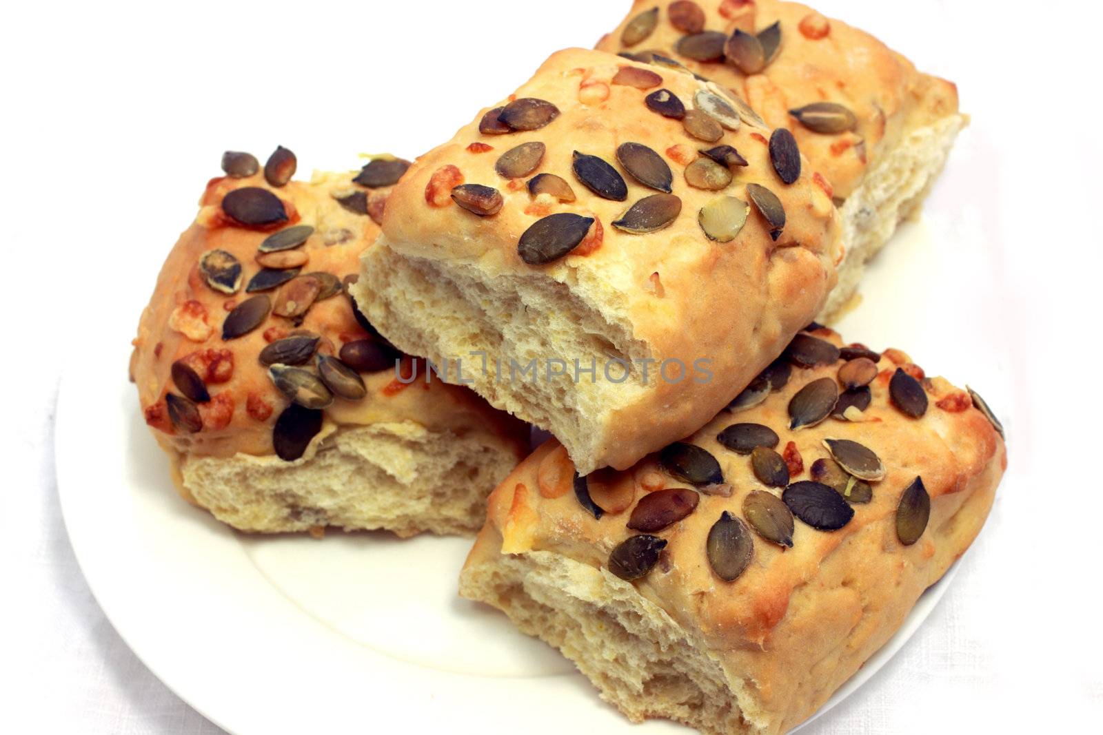 small bread with pumpkin seeds close up isolated