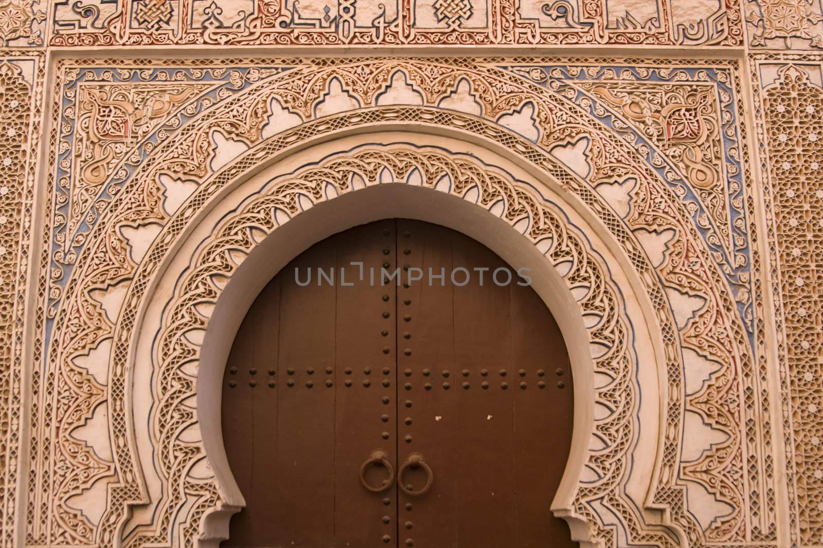 Entrance to a traditional riad in the shape of a key hole in Marrakesh, Morocco