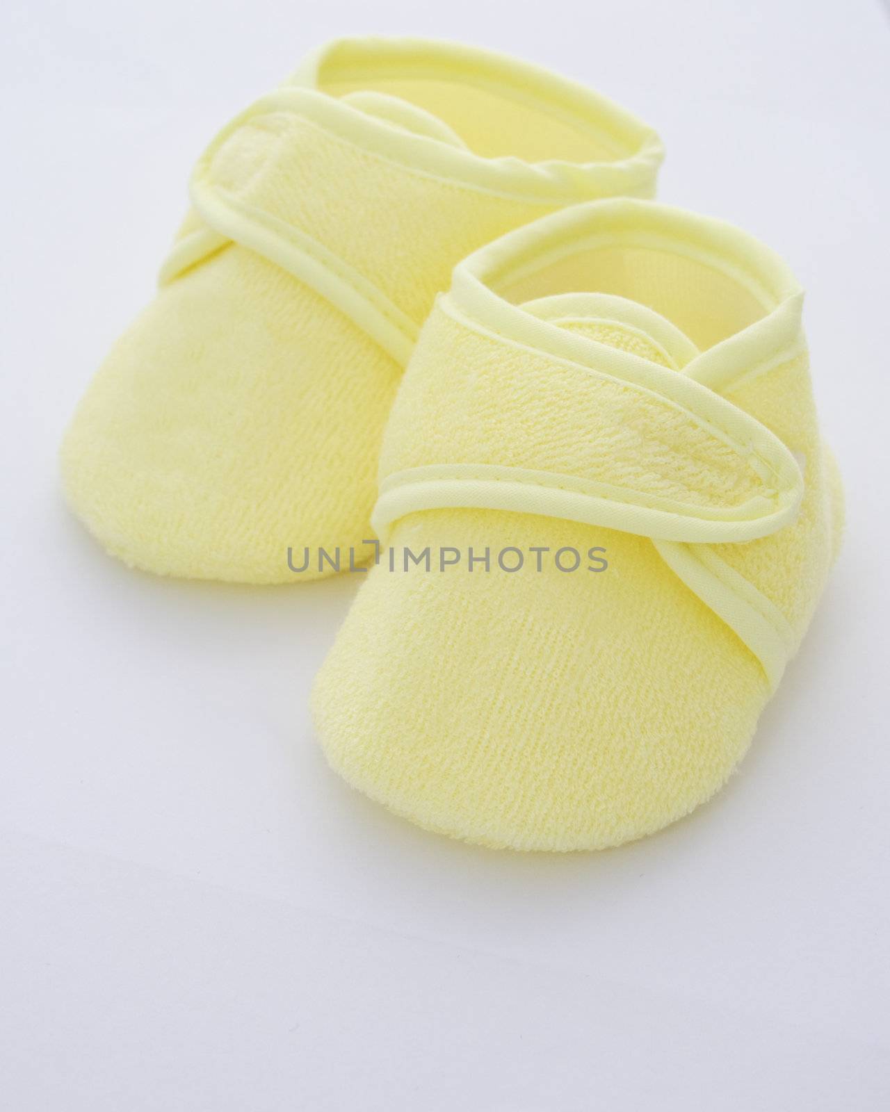 babies shoes in a yellow towelling fabric