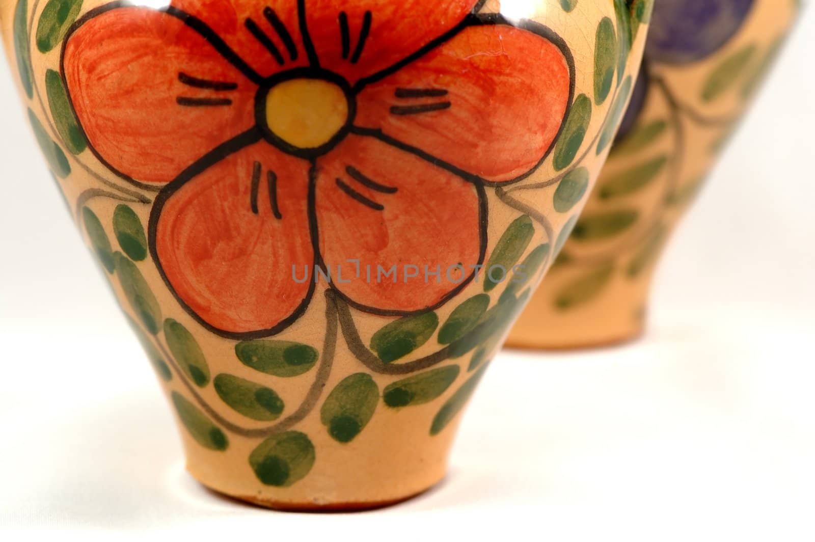 Ceramic pot with flower painting over white