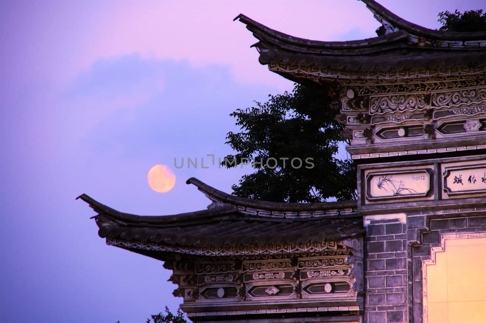 Ancient Chinese architecture over sky and moon, taken at late evening