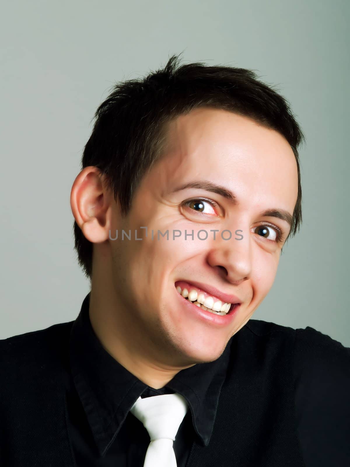 Happy young businessman laughing