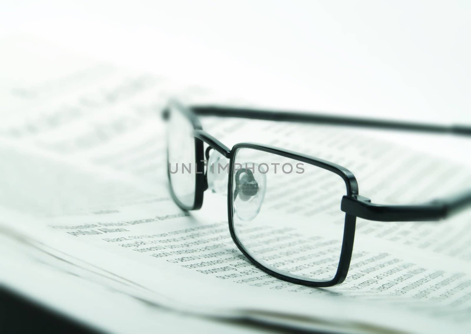 Eye glasses and newspaper