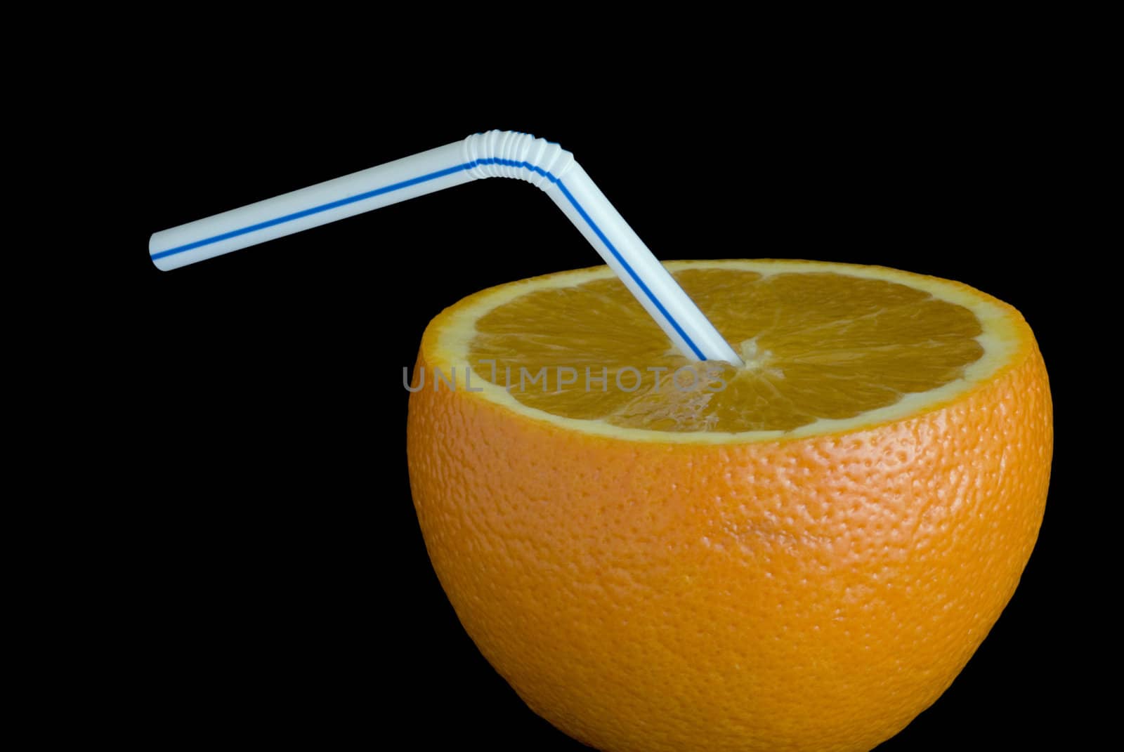 orange juice, a ripe orange and a drinking straw