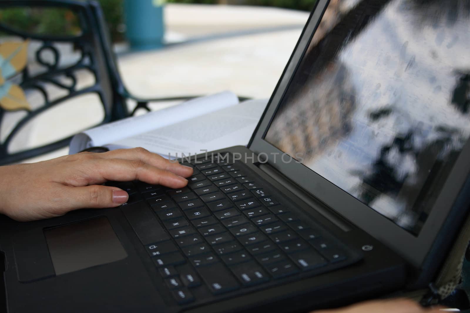 Working on on a laptop in a garden.