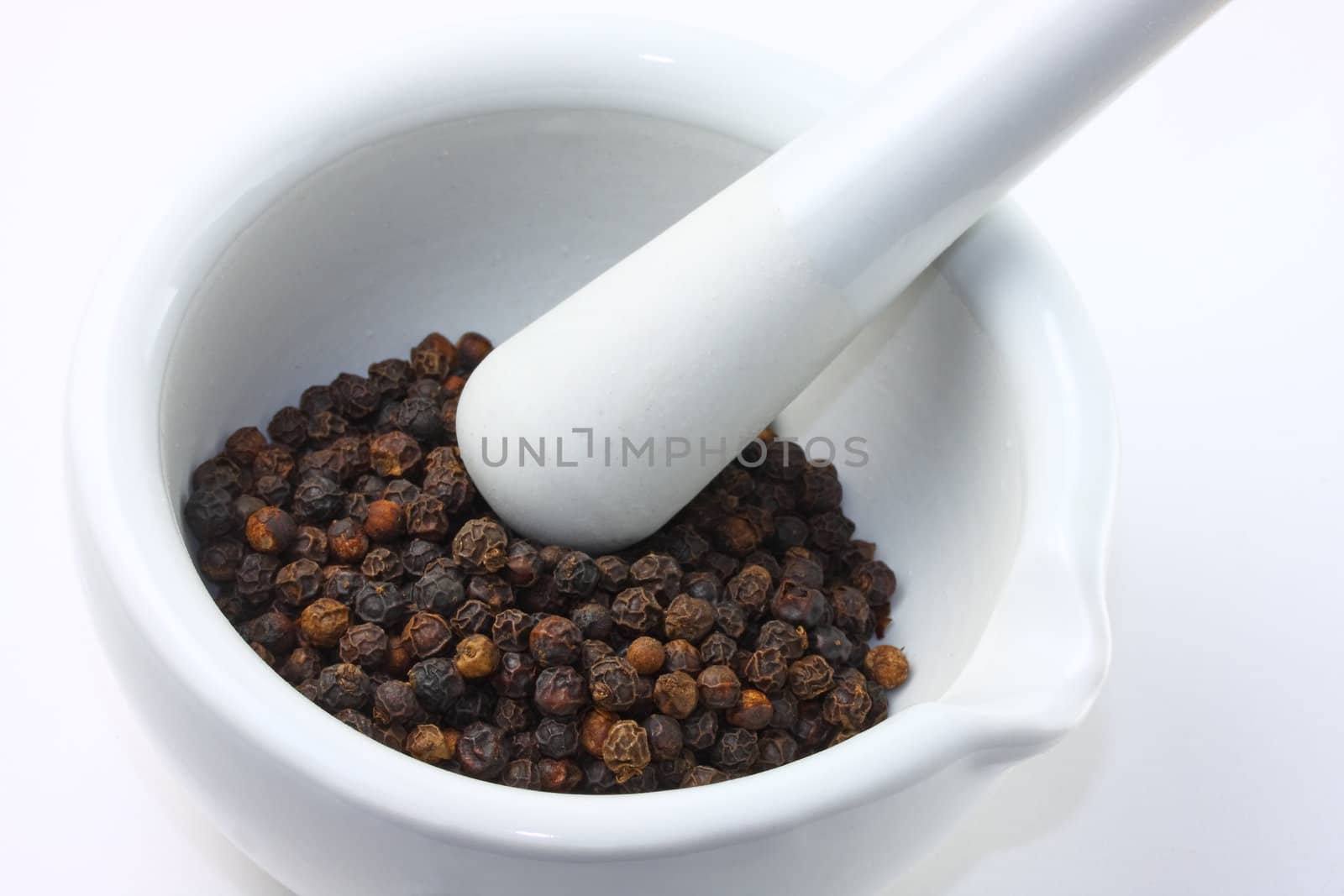 Mortar and pestle with peppercorns.
