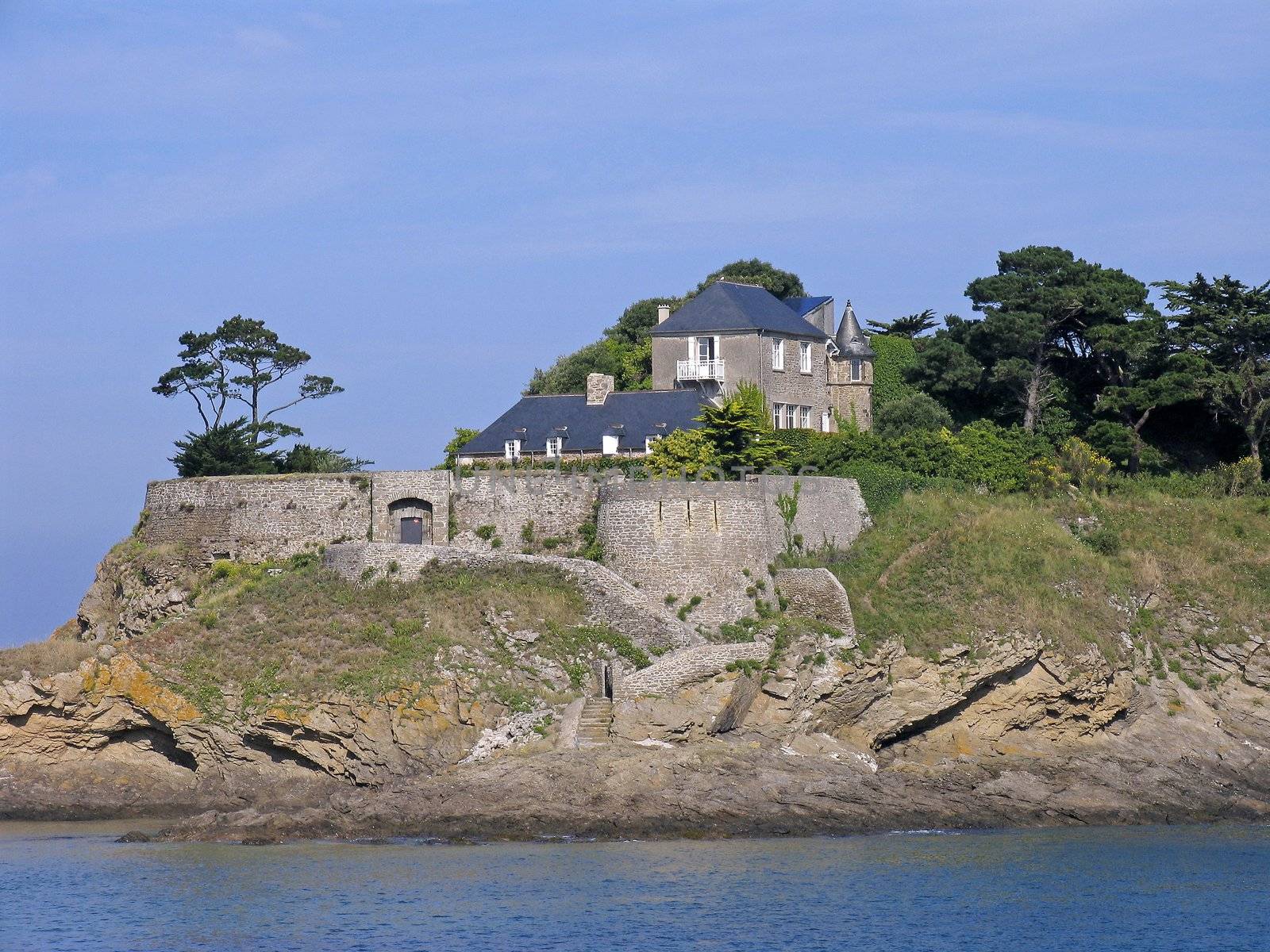 Anse du Guesclin, Pointe du Grouin with a castle is on an little island in Brittany, North France