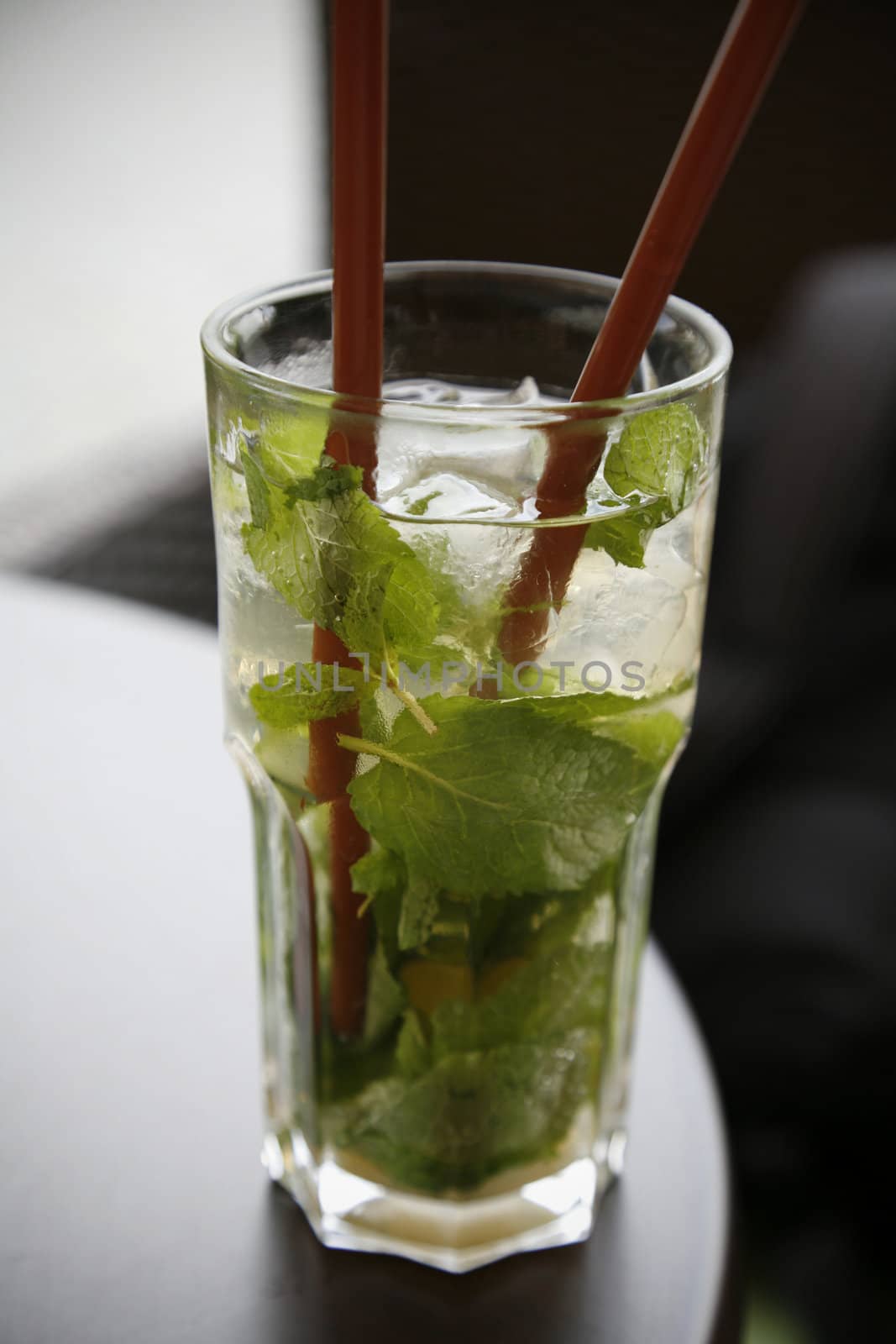 Nice cold Mojito long drink on cafe table at summertime.