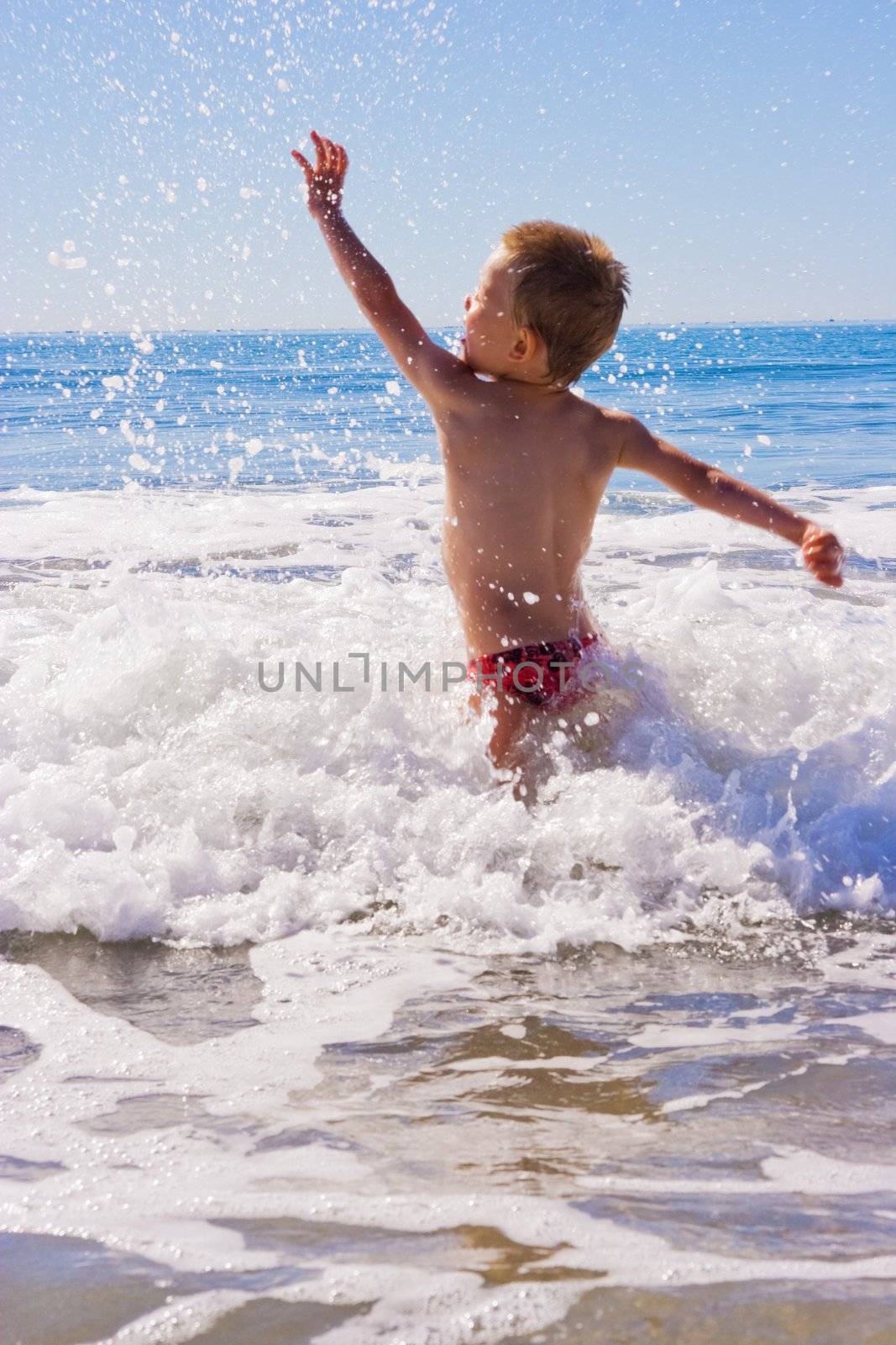 A Young child playing in the sea