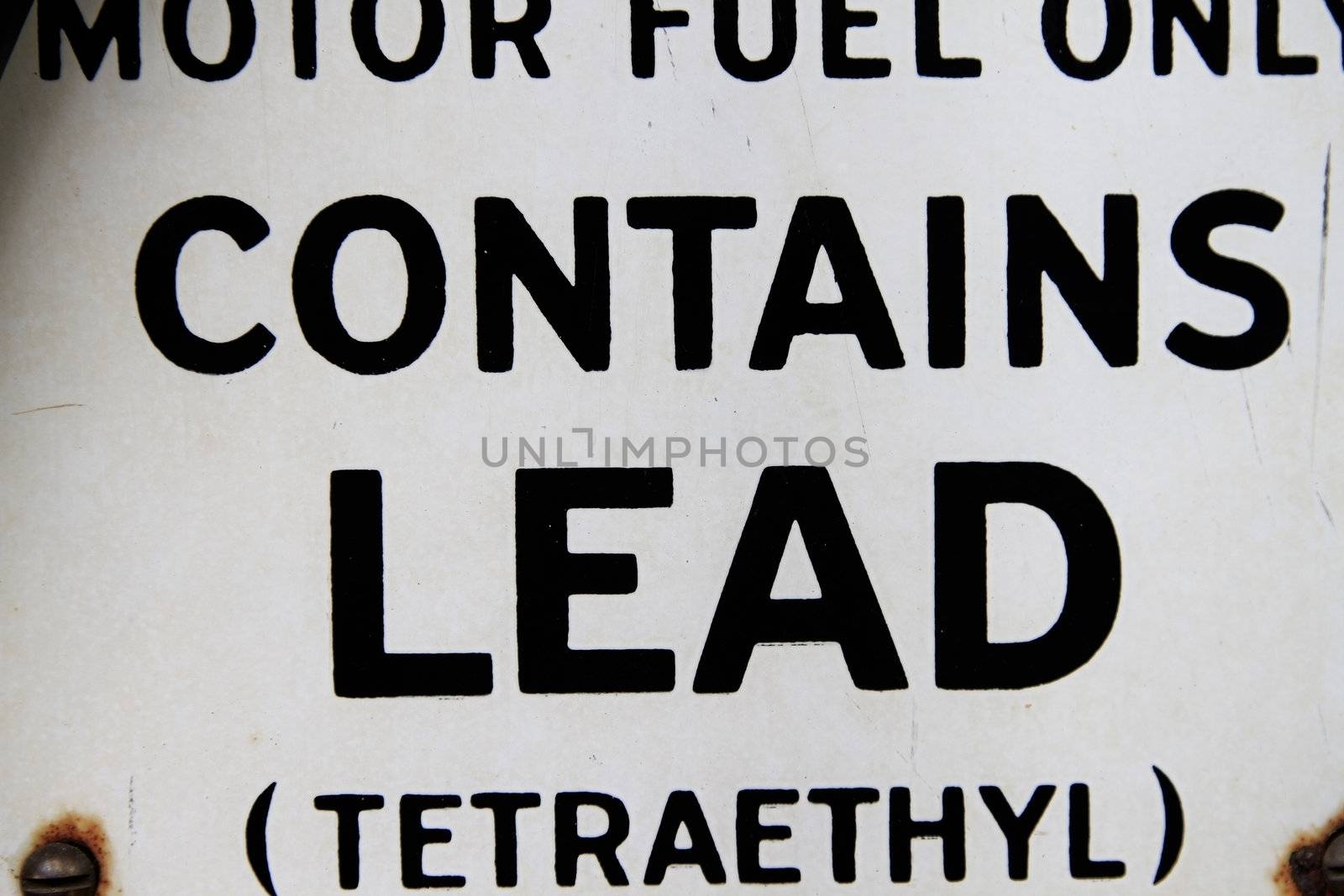 Vintage gasoline pump with wordings taht contains lead -tetraethyl.