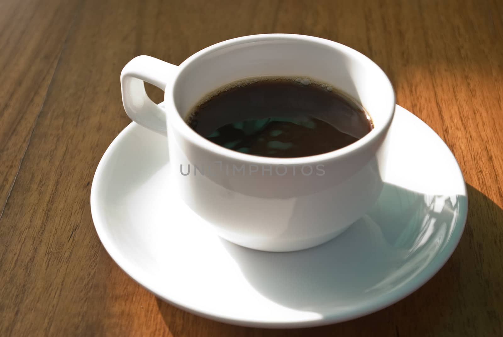 Hot coffee cup in the morning on wooden table