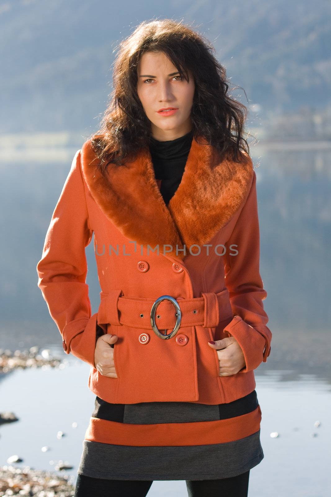 Very beautiful model in fashionable clothing at Autumn Lake