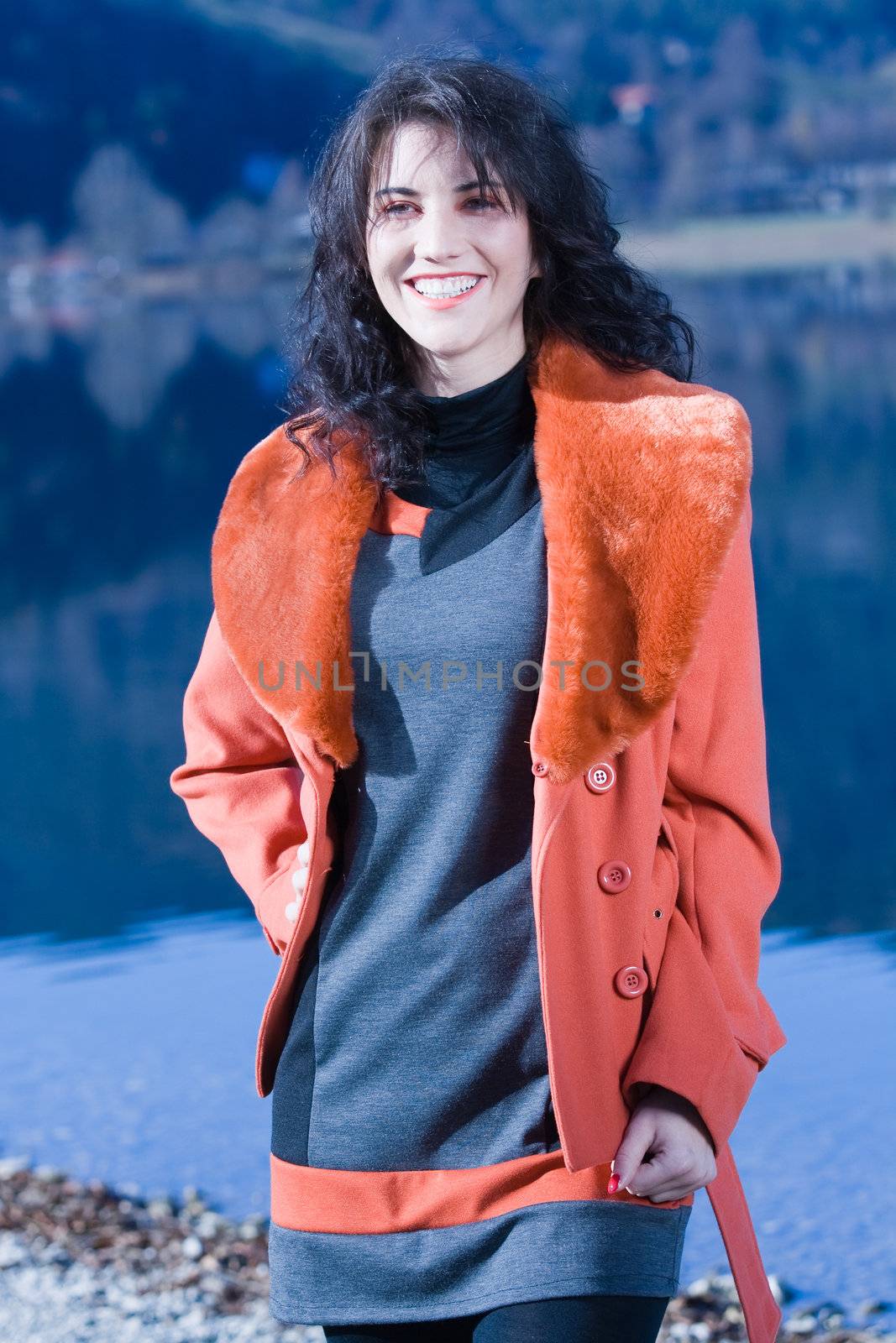 Very beautiful model in fashionable clothing at Autumn Lake