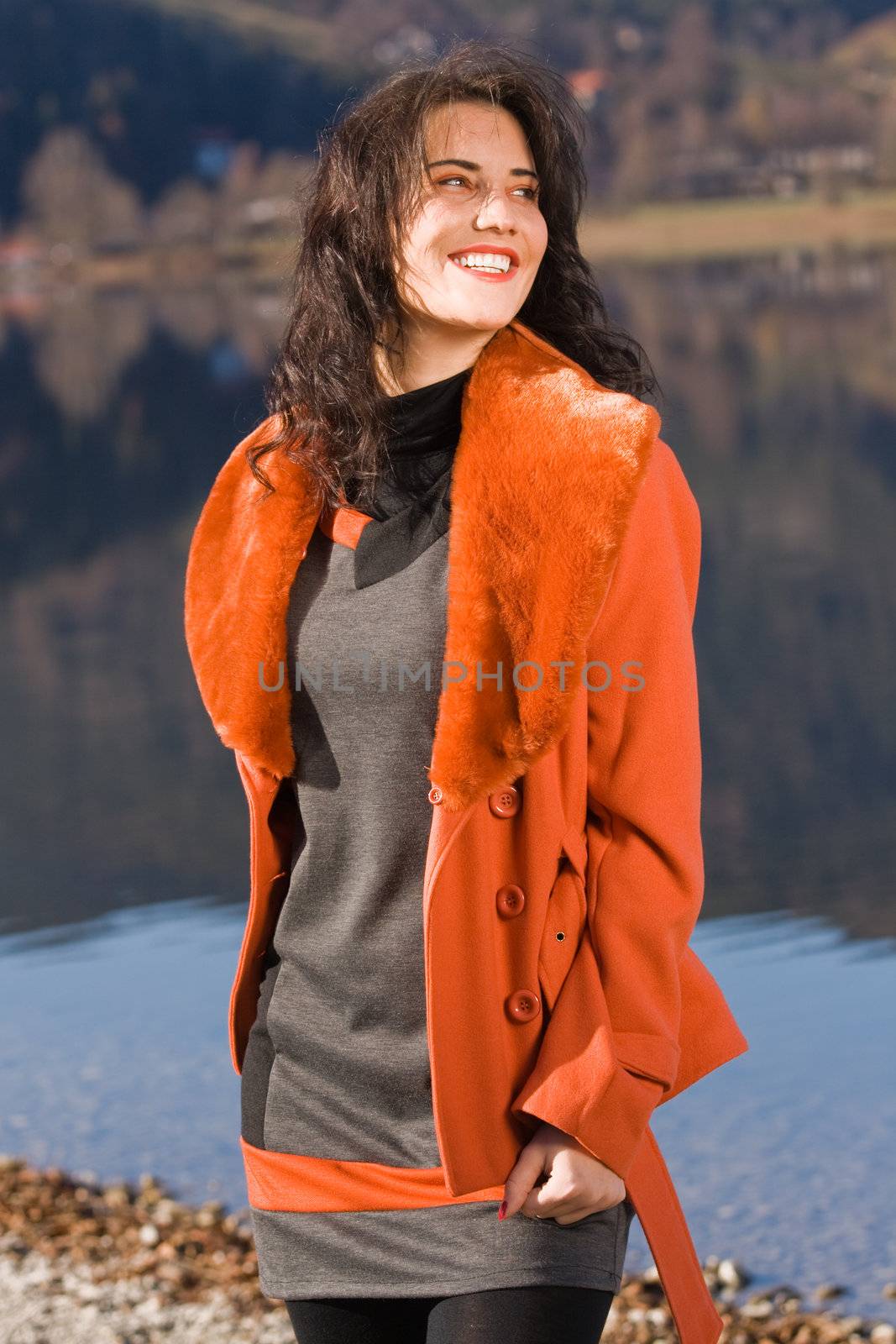 Very beautiful model in fashionable clothing at Autumn Lake