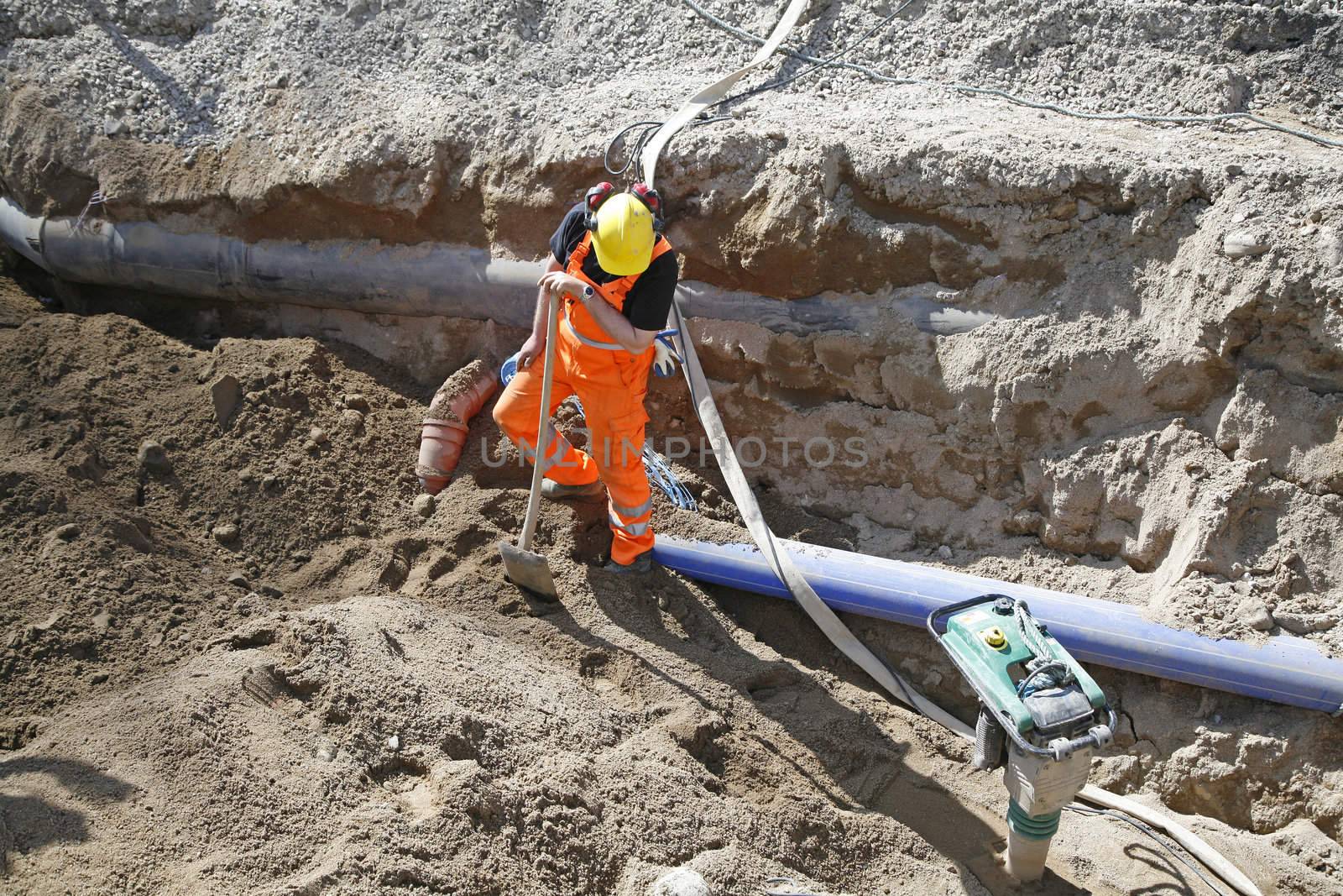 Worker changing some pipes to the district municipal heating.