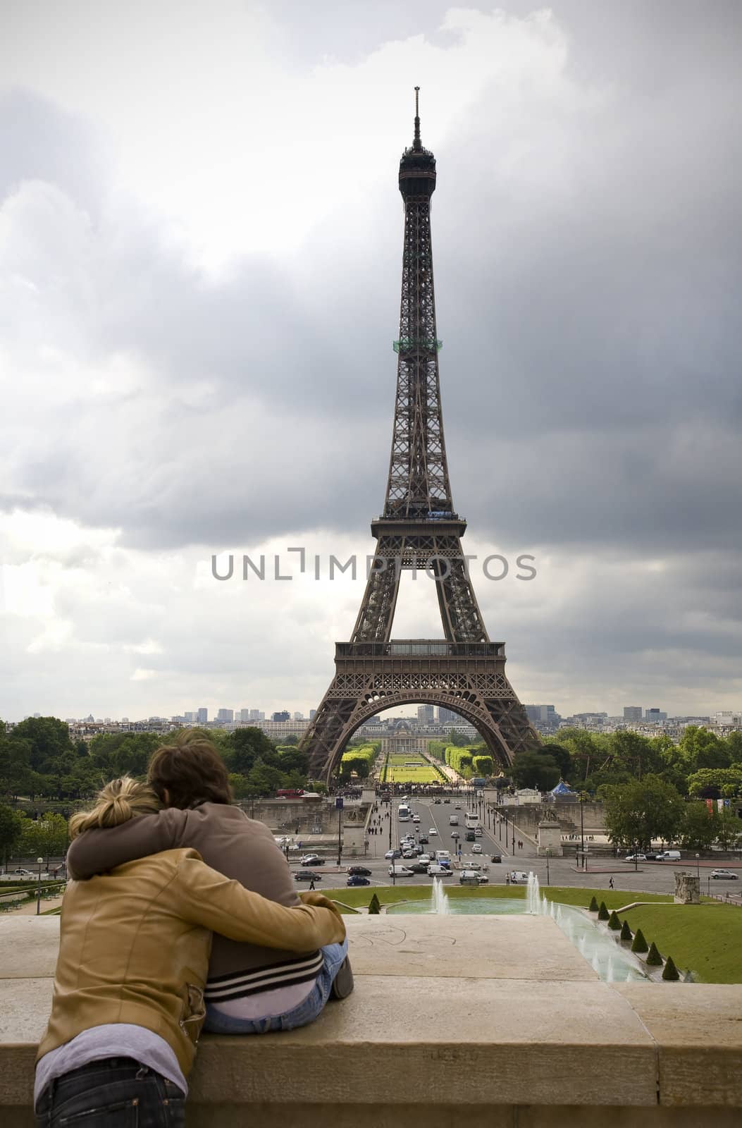 Young couple in love looking at the Eiffel Tower from Trocadero - Paris, France.