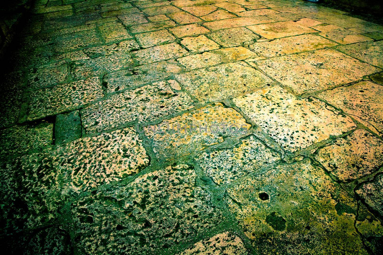 Dream of Split. Artistic work to make an old dreamlike look. Marble stone in alley - Split, Croatia. Traces of several hundred years of daily use to be seen. Cross processed.