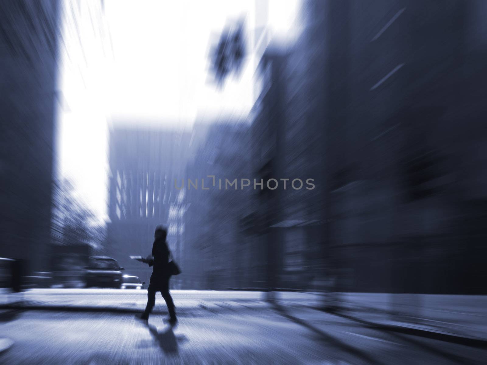 Person crossing street in huge city. Low afternoon light. Space for text.