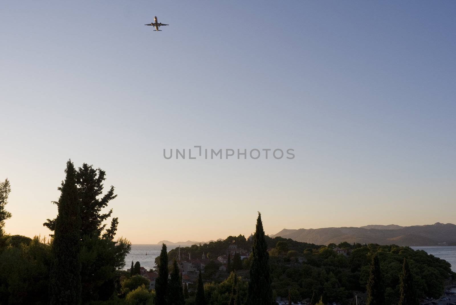 Aeroplane ready for landing in the Airport of Dubrovnik - seen from my balcony in Cavtat, Croatia at sunset.
