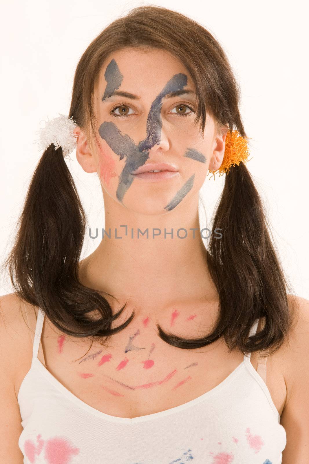 Young woman painting with paint on his face and hands