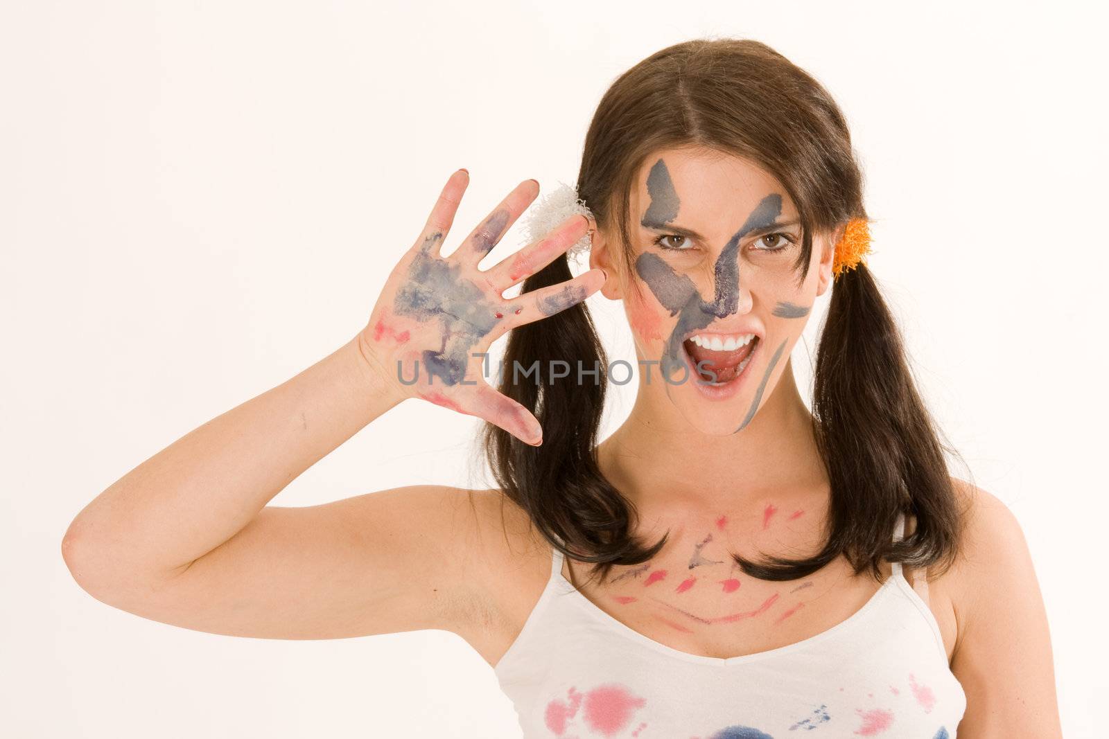 Young woman painting with paint on his face and hands