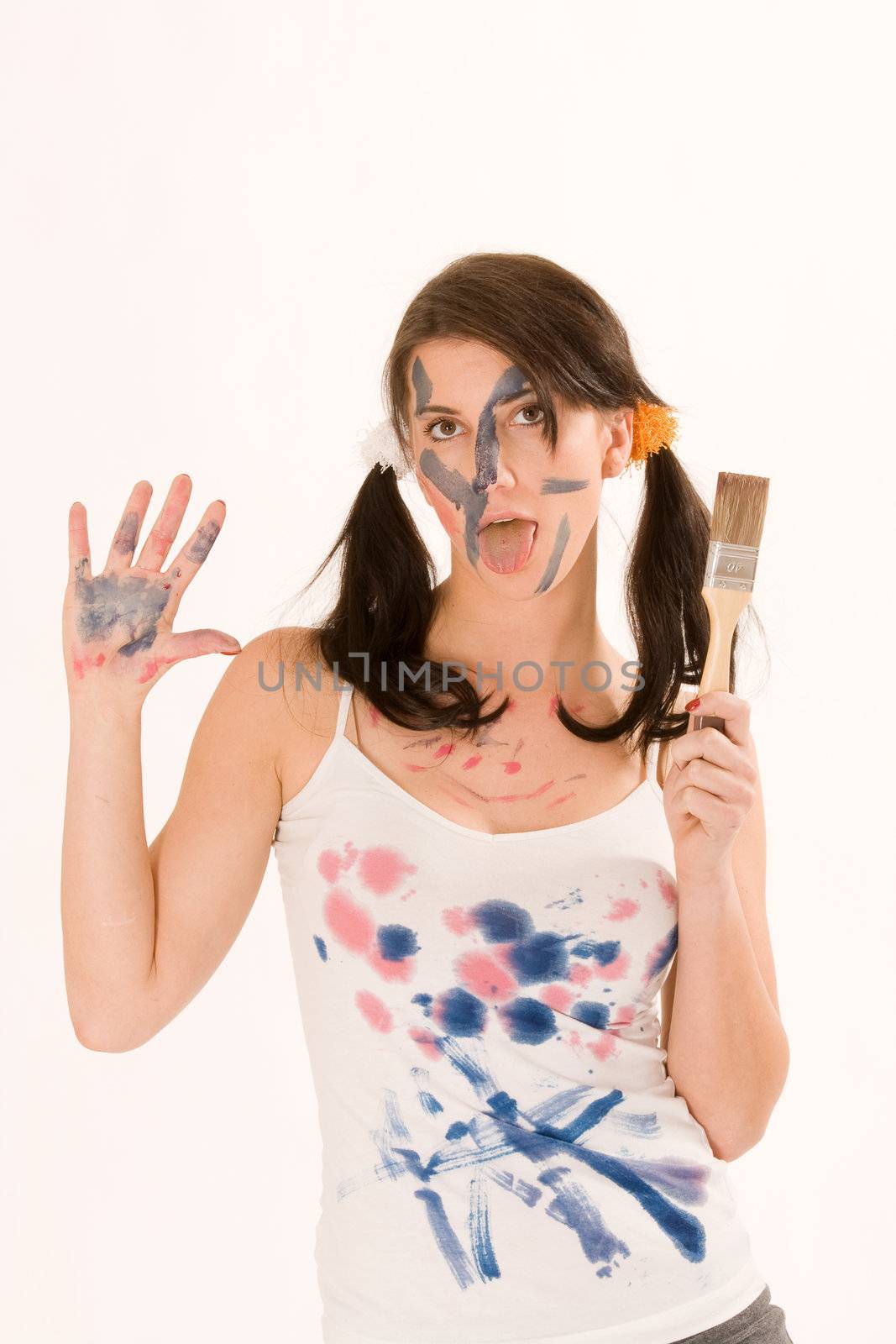 Young woman painting with paint on his face and hands