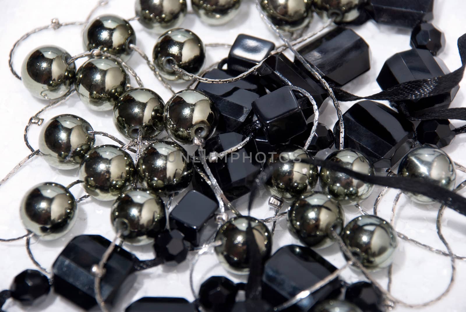 Closeup black pearls necklace on the white background.