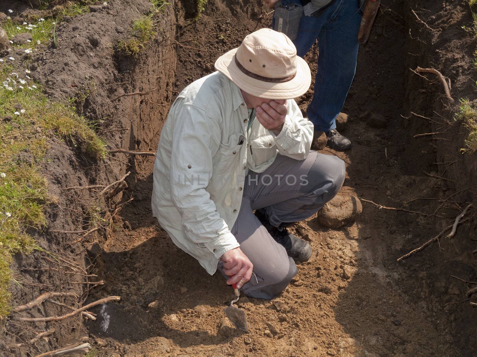 Archaeologist excavating outsite Nyborg Castle, Funen, Denmark.