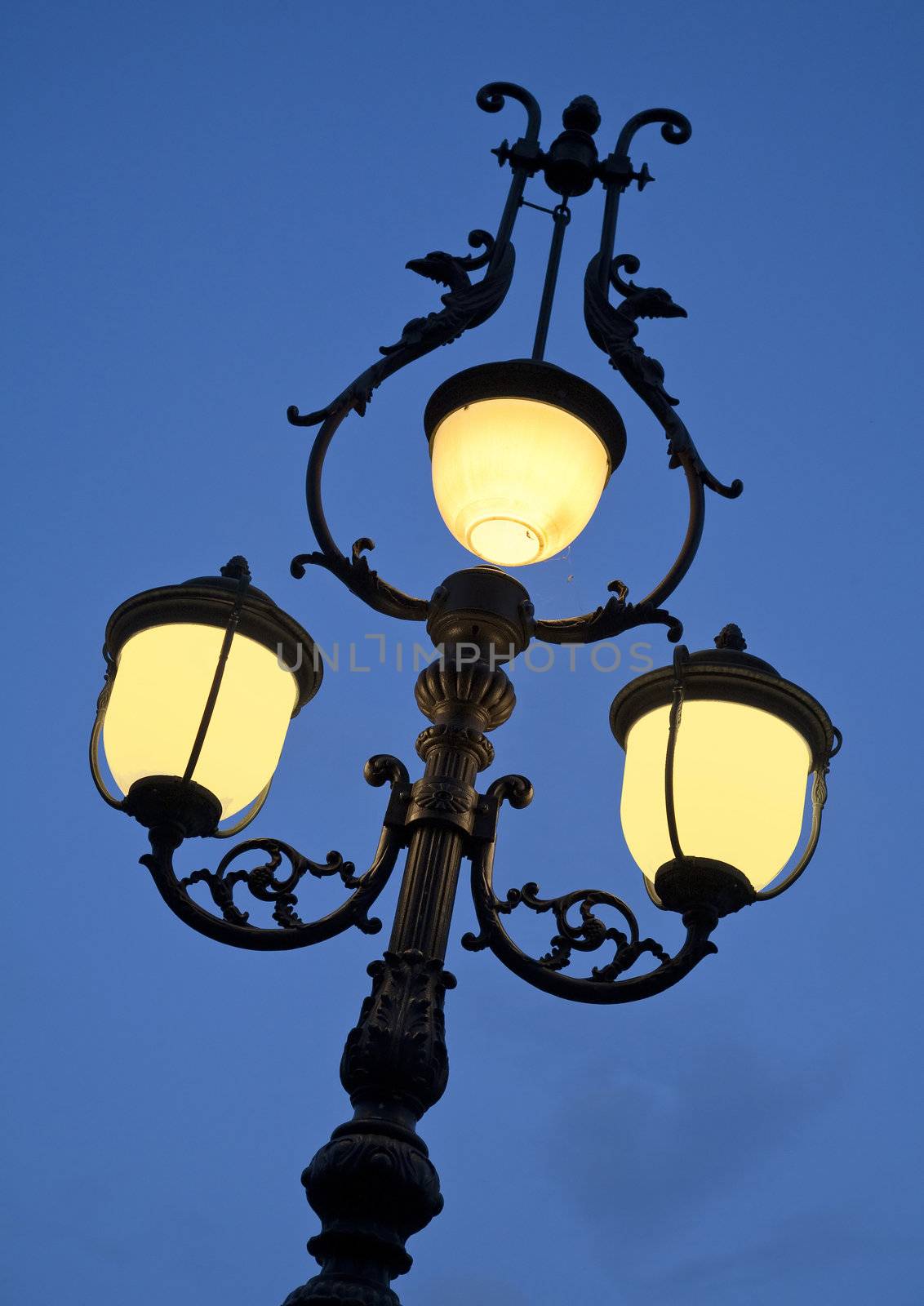 Nice old lamp at dusk. Seen in Lorezo - region of Marche, Italy.