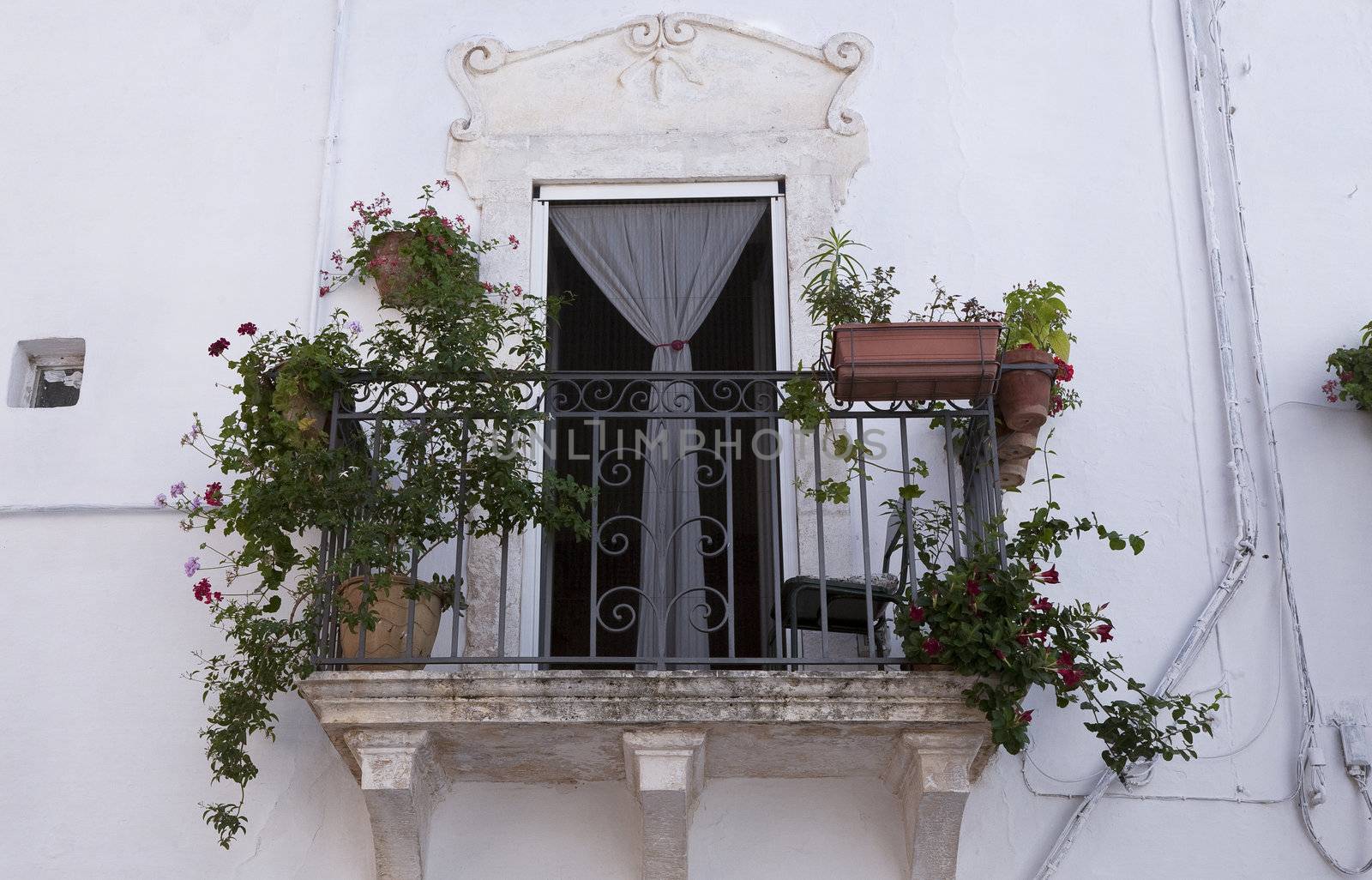 Nice balcony in the old part of Ostuni the province of Brindisi, Puglia, Italy. A city with a population of 32.000 inhabitants located about 8 km from the coast.