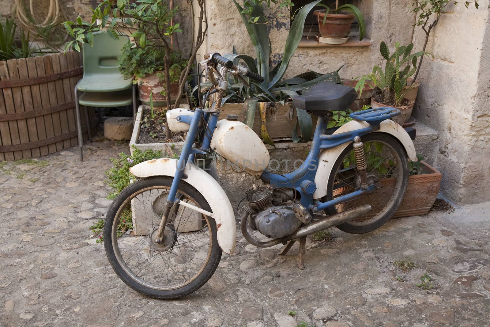 Vintage Italian moped in old courtyard - Basilicata, Italy.