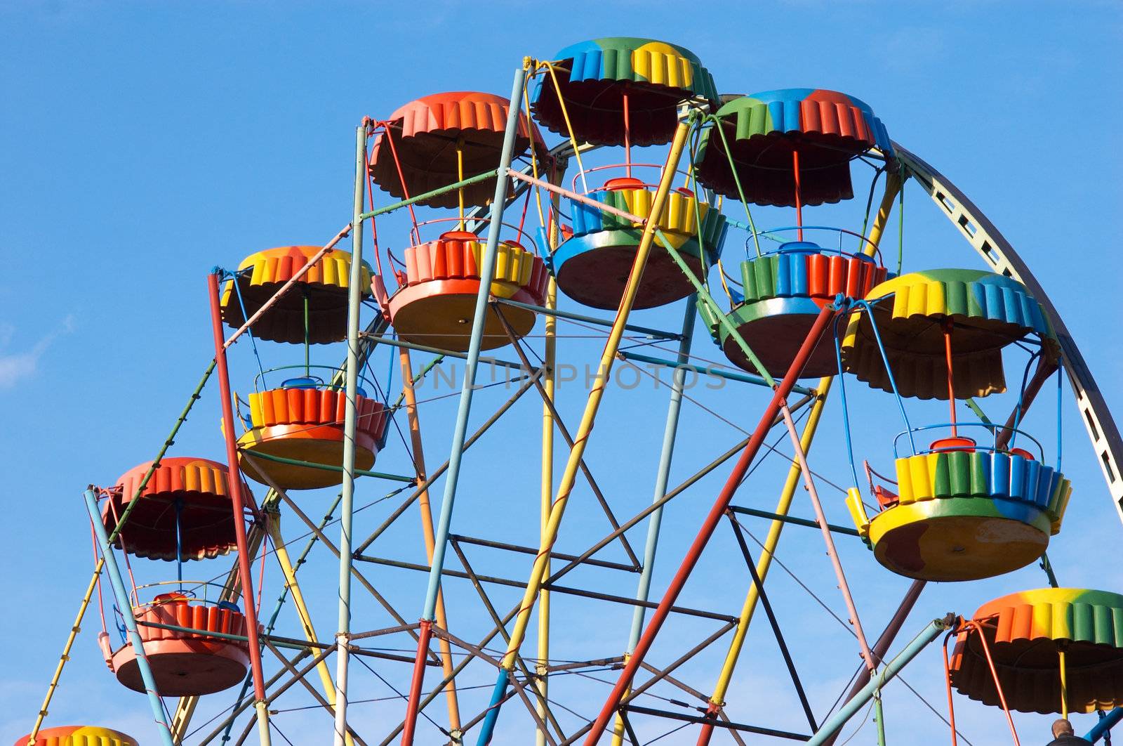 silhouette of colorful joy wheel in amusement park