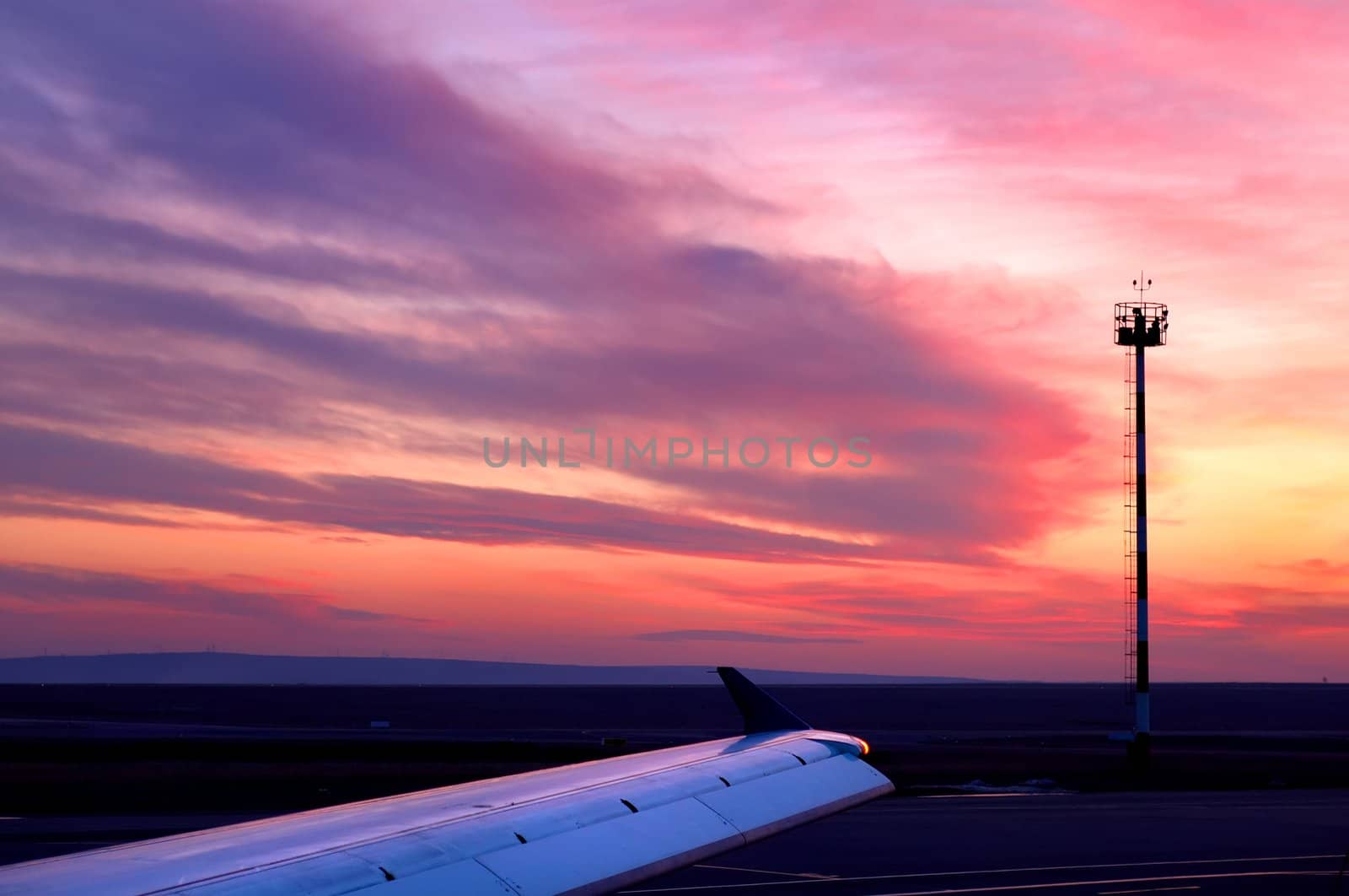 Sunset at airfield (coudscape and aircraft wing). 