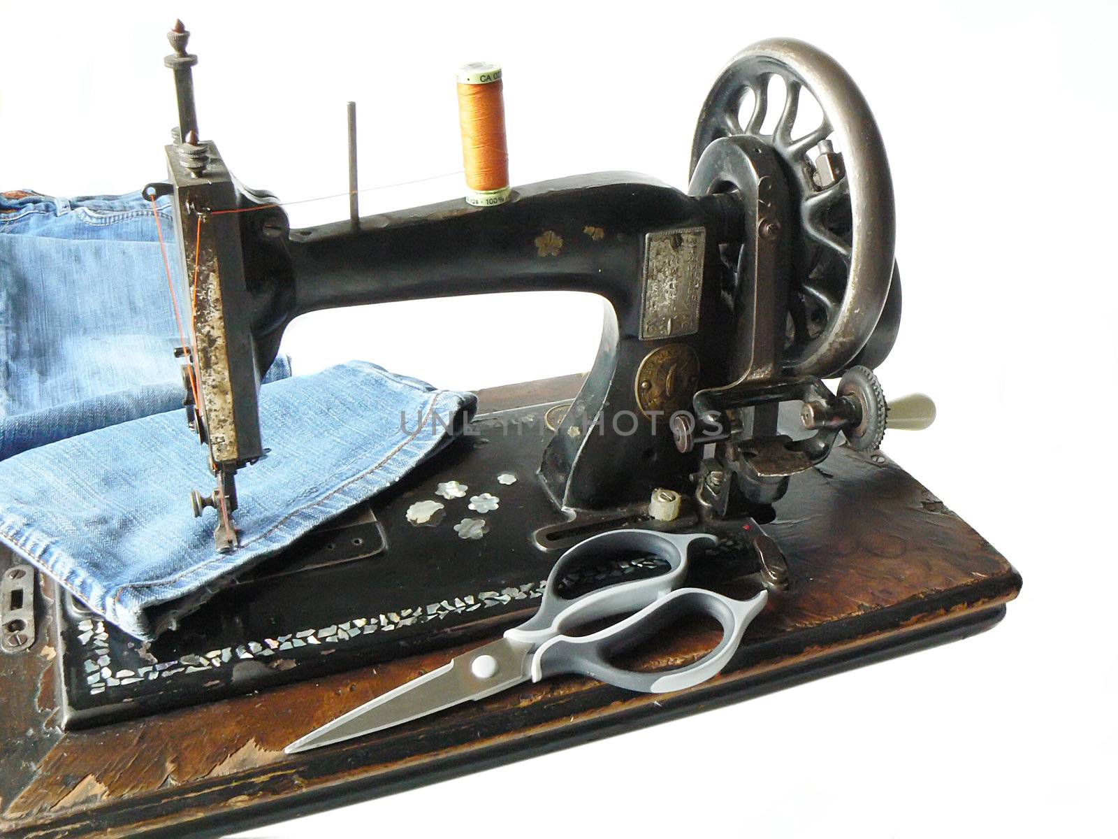 Vintage sewing machine and modern jeans