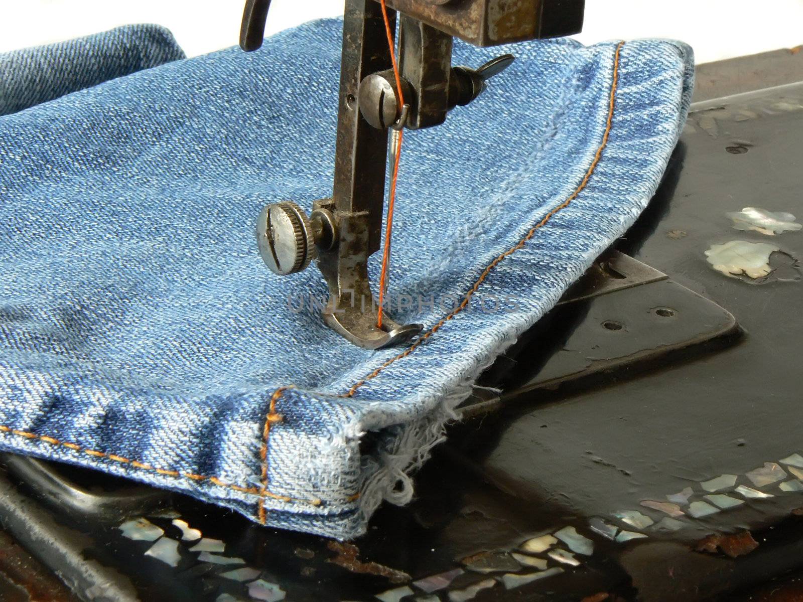 clousup of old sewing machine and jeans