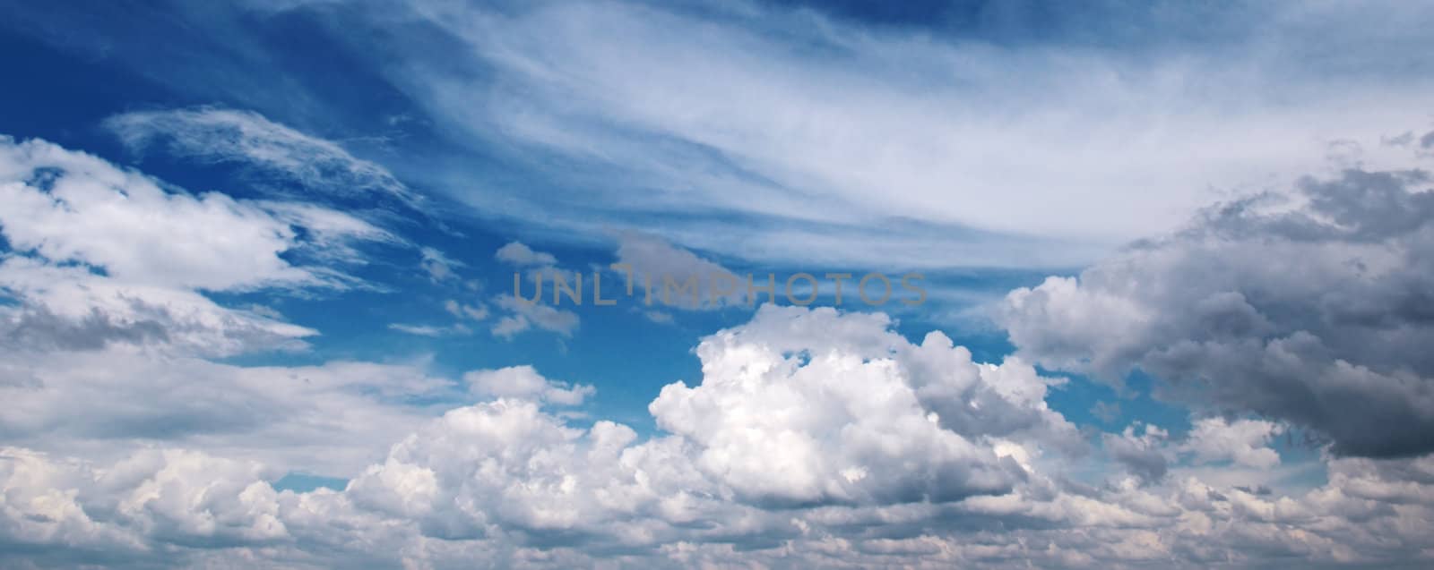 white fluffy clouds in the blue sky                                    