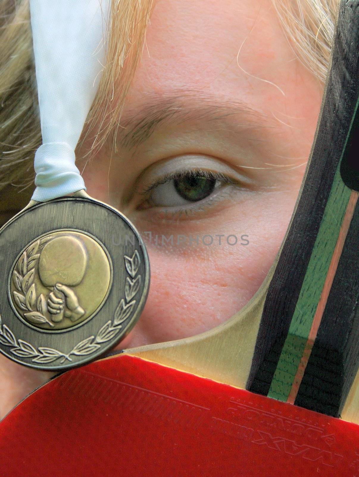 A Young Female with Table Tennis Bat and Gold Medal.