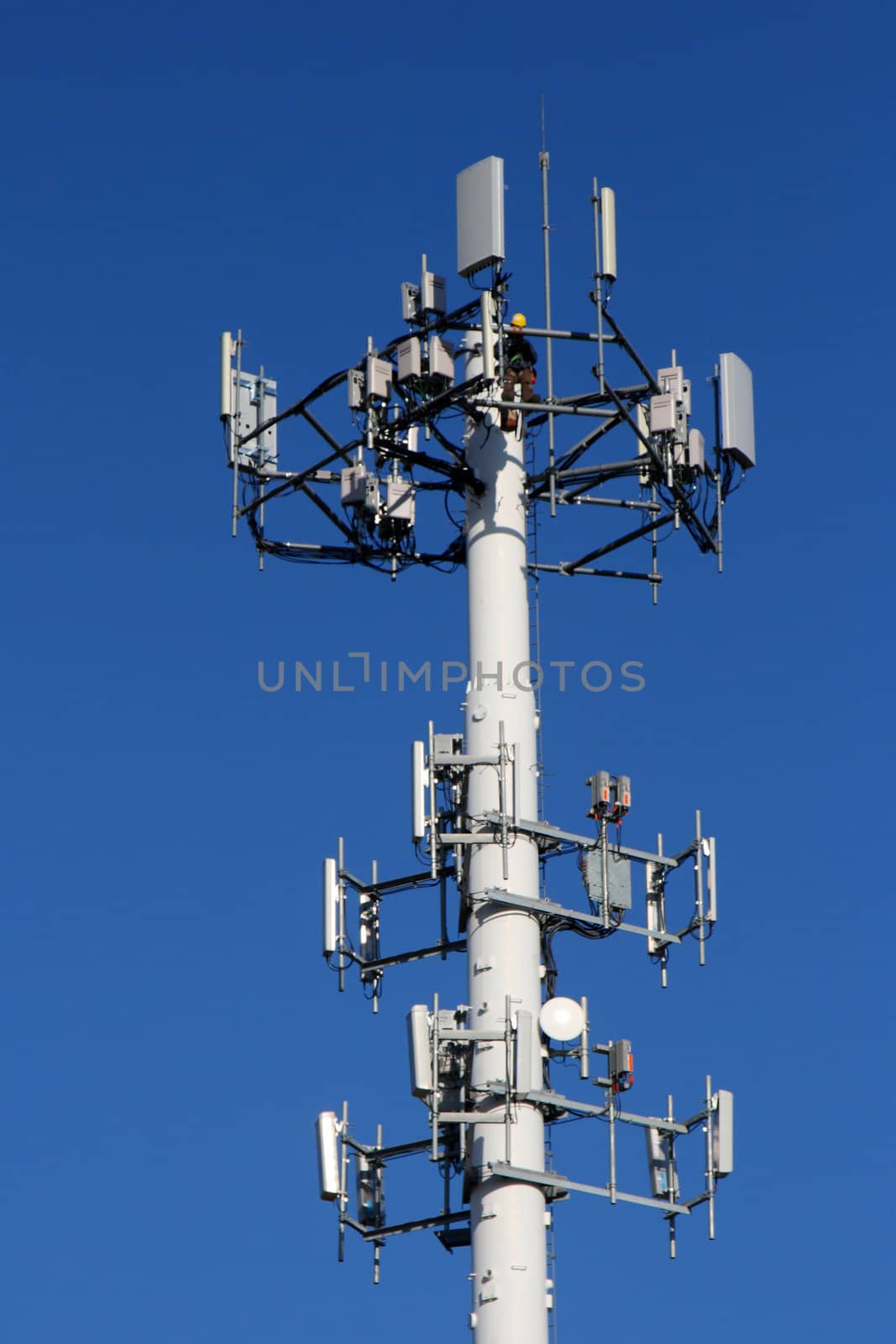 communications tower with worker repairing