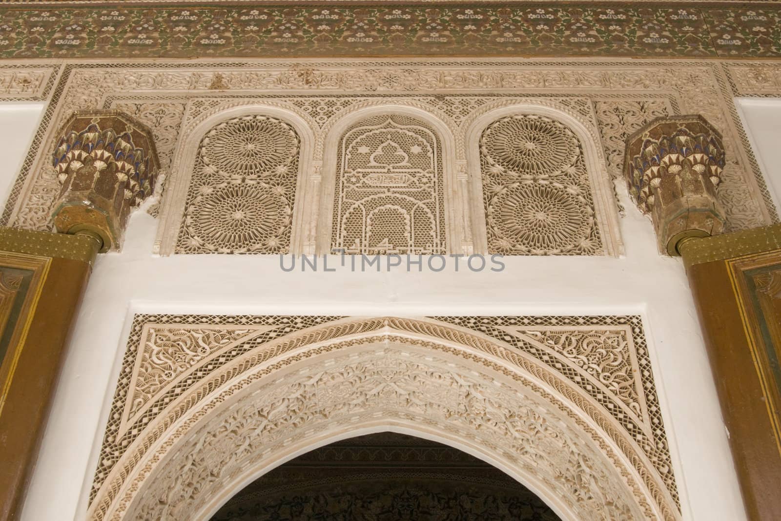 Ornate entrance arch and doorway inside the 19th century El Bahia Palace in Marrakesh, Morocco.