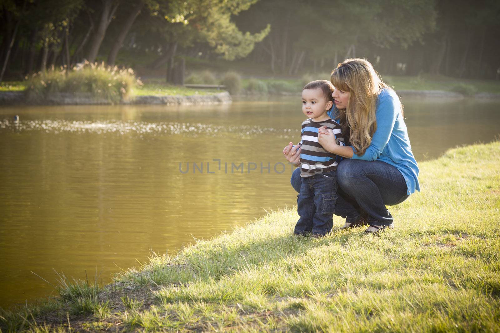 Happy Mother and Baby Son Looking Out At The Pretty Lake.