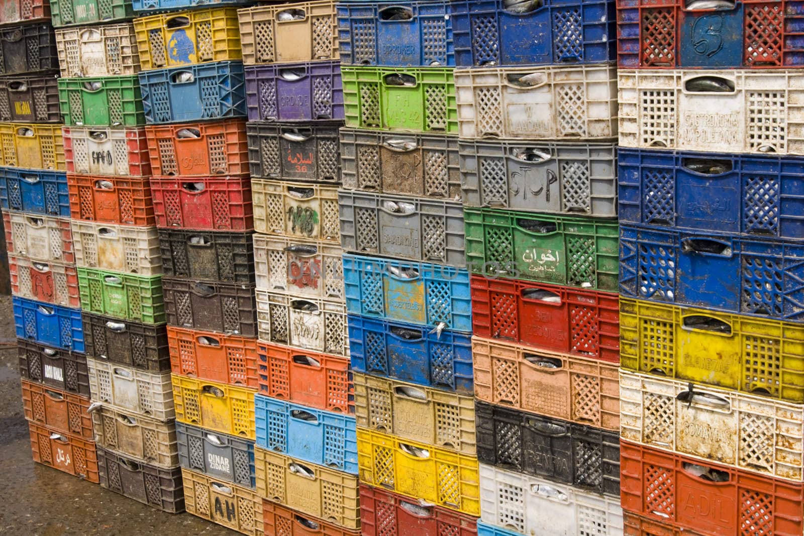 Stack of colorful packing cases containing recently landed fish in the fishing village of Essaouira, Morocco.