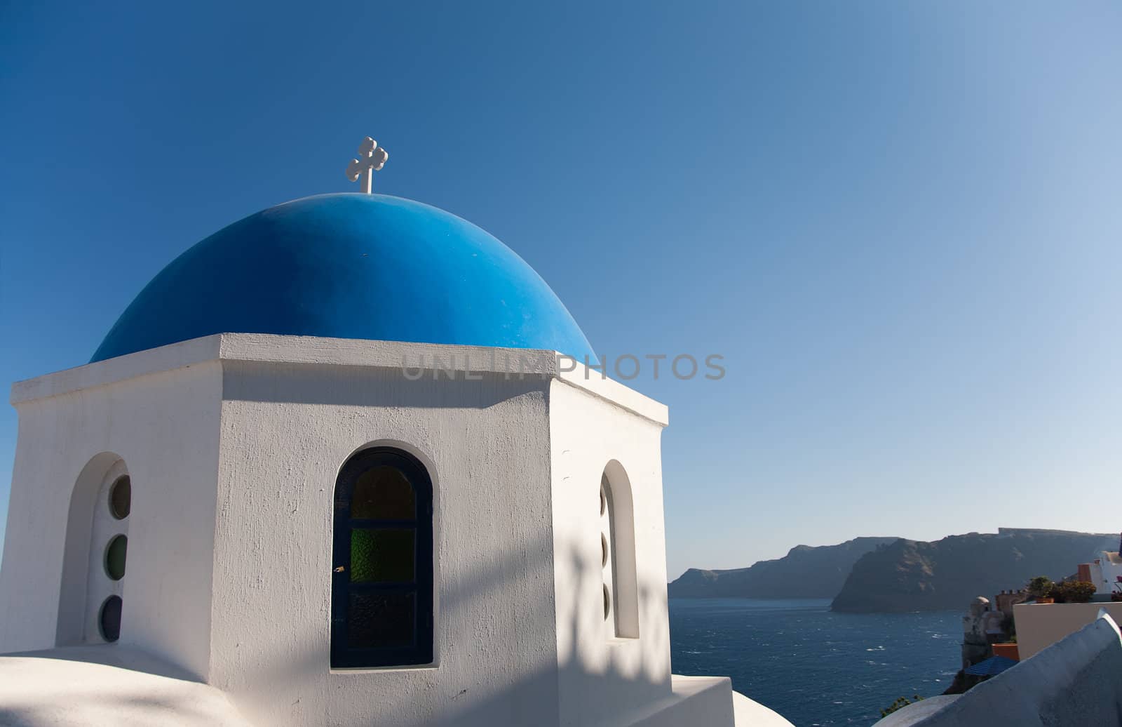 Orthodox temple in Oia, Santorini, Greece at daytime with blue sky