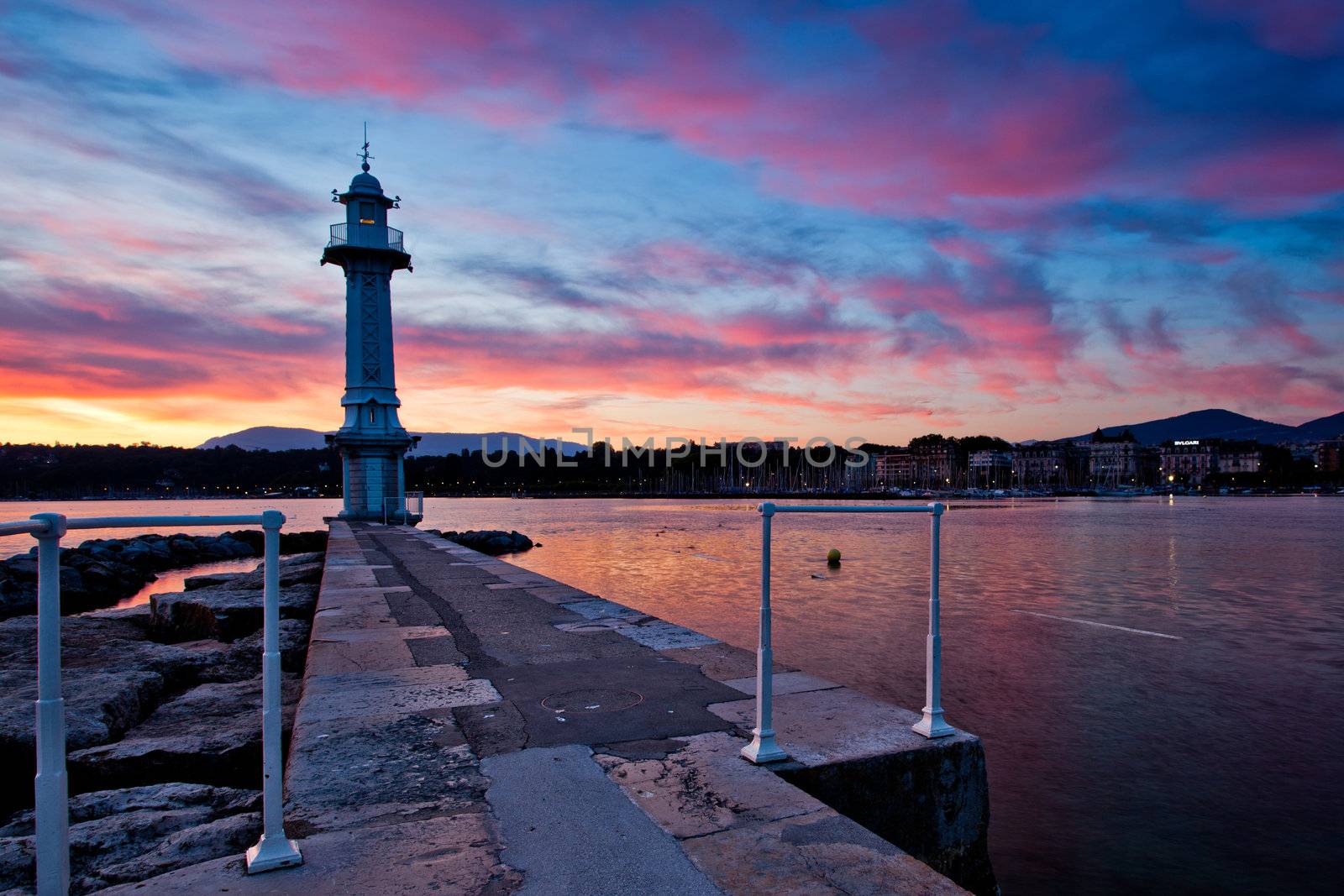 Lake Geneva lighthouse with colourful sunrise in background