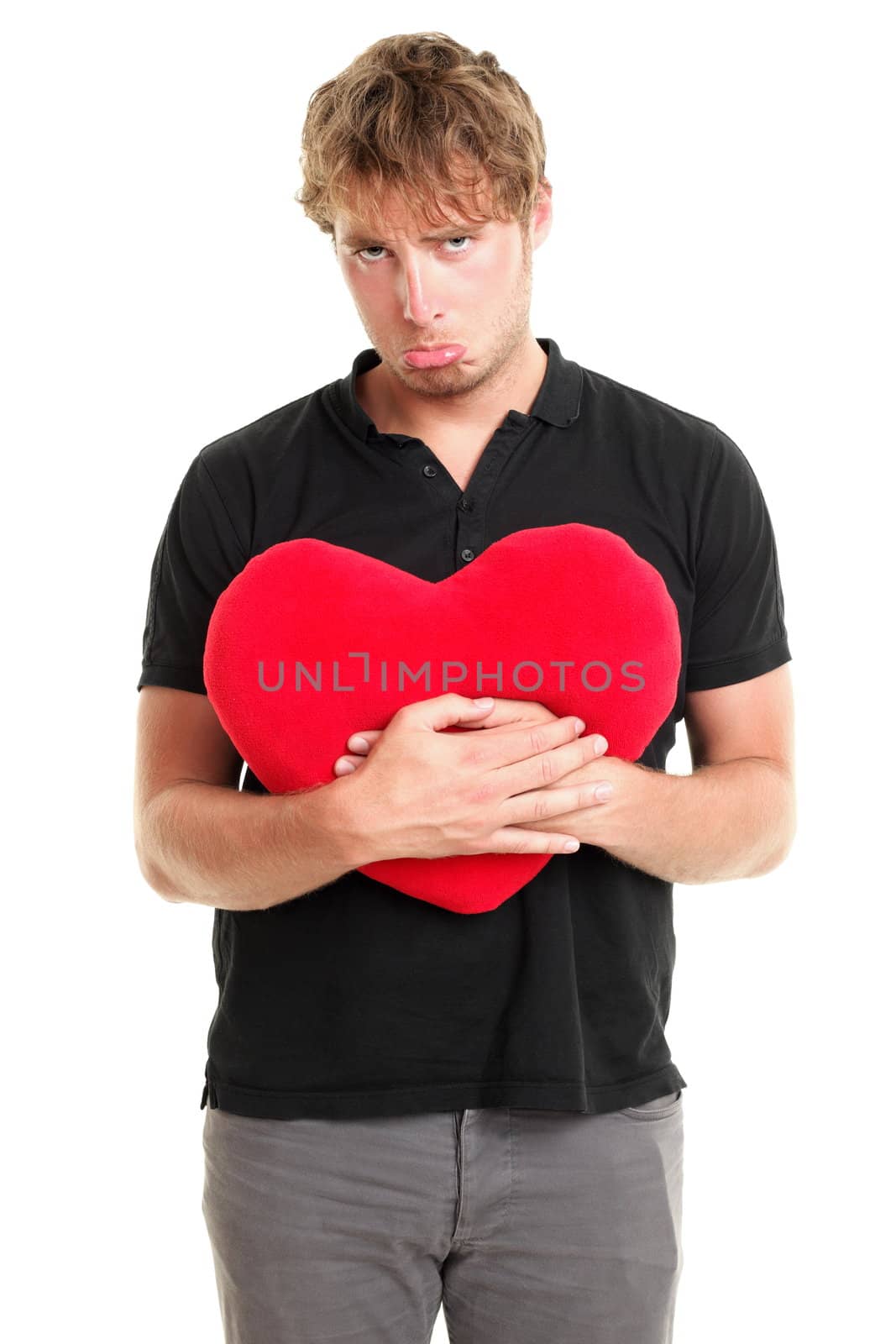 Unhappy love. Funny image of sad broken heart valentines day man holding red heart isolated on white background.